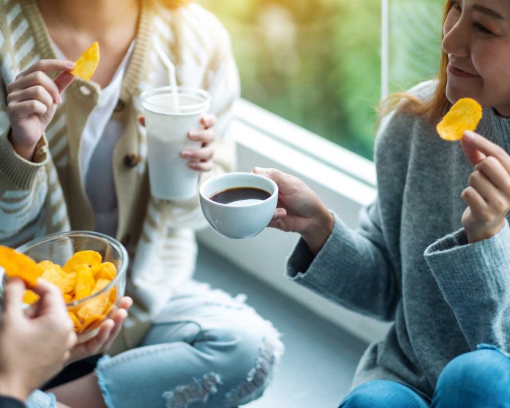 Employees sharing snacks and coffee.
